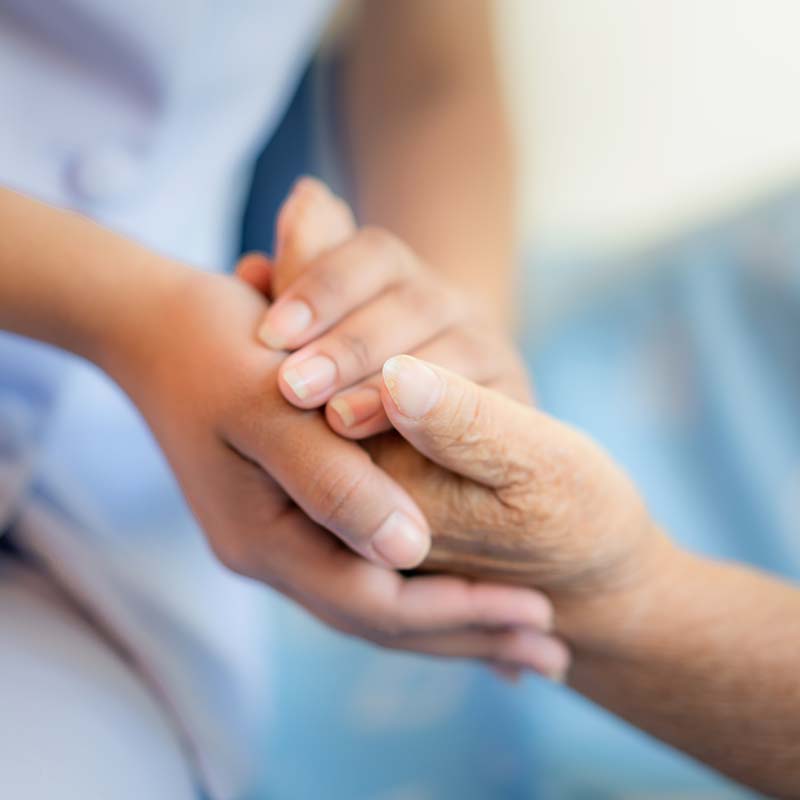 holding hands with long term care patient